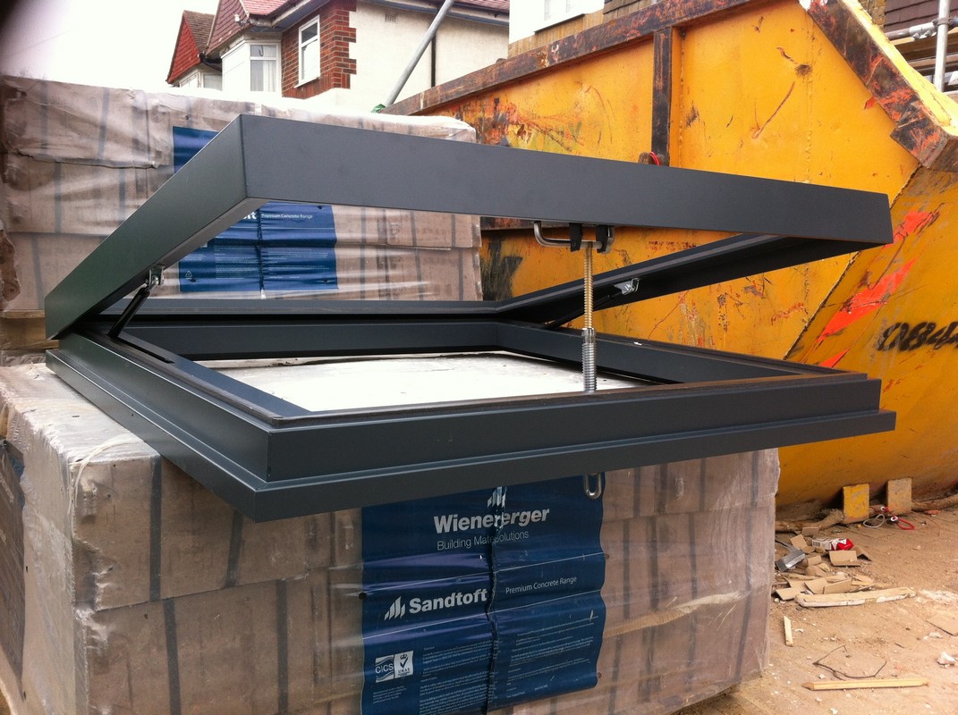 Opening flat roof skylight in anthracite grey installed in Kentish Town