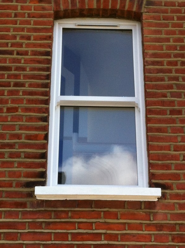 uPVC sash window on Victorian red brick house in Kentish Town